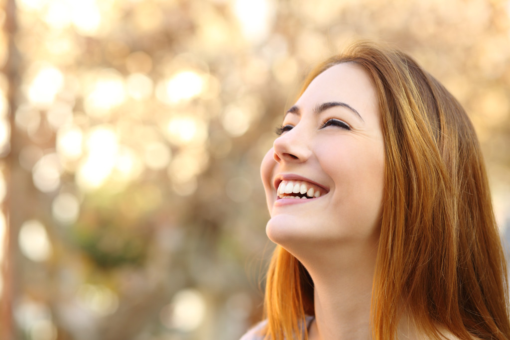 Portrait of a woman laughing with a perfect teeth on a warmth background
